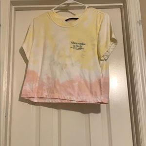 A yellow white and pink crop top